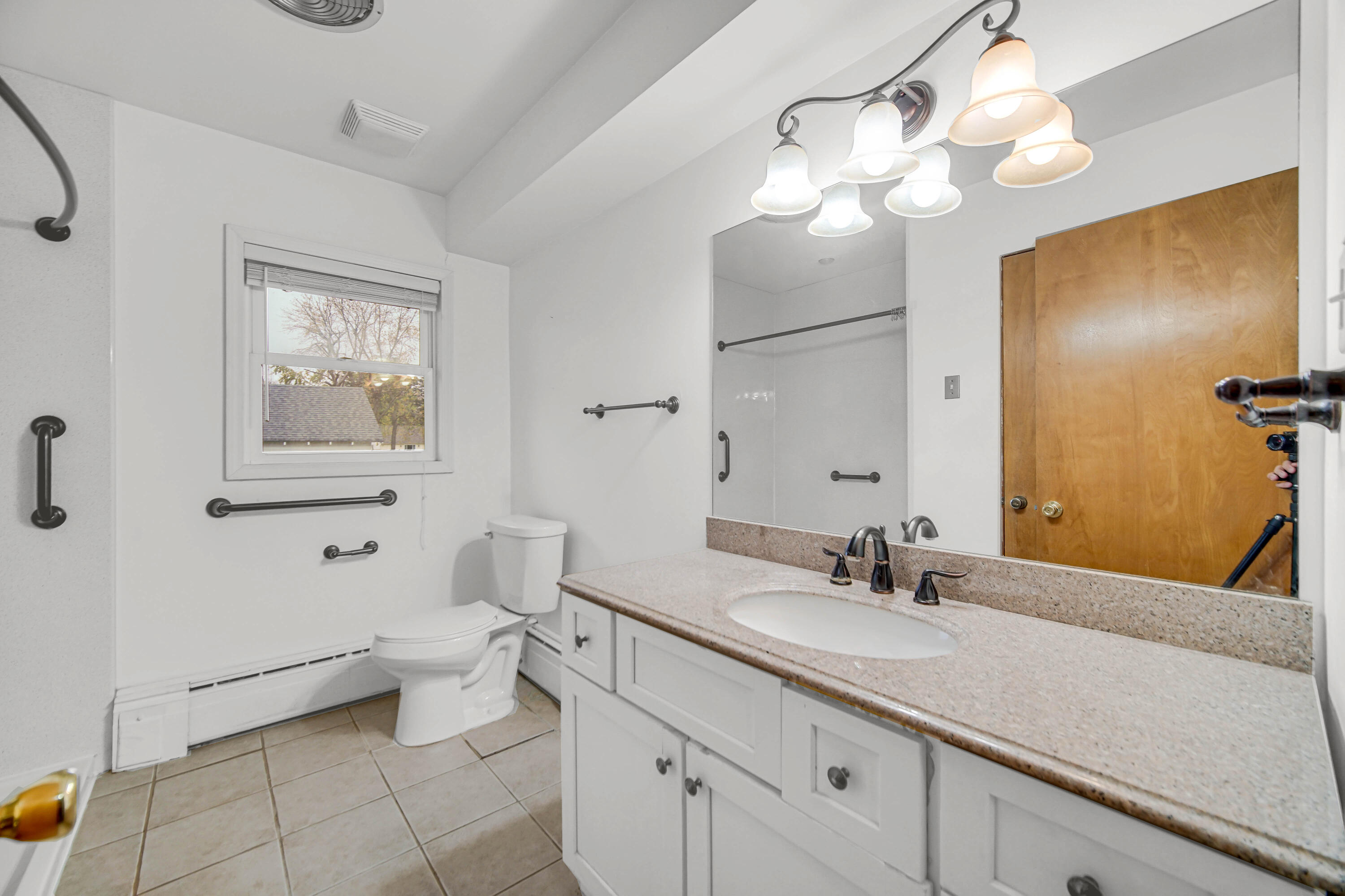 204 North Main Street Kouts, IN 46347 - Photo 7 of 28 a bathroom with a toilet a sink and mirror
