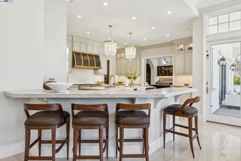 a living room with furniture fireplace and a large window
