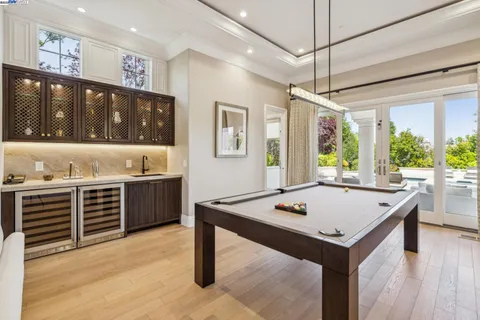 a bathroom with a sink a mirror and a painting