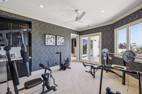 a living room with furniture a large window and a potted plant