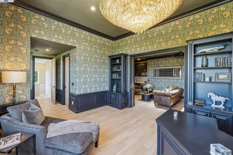 a large white room with a large window and wooden floor