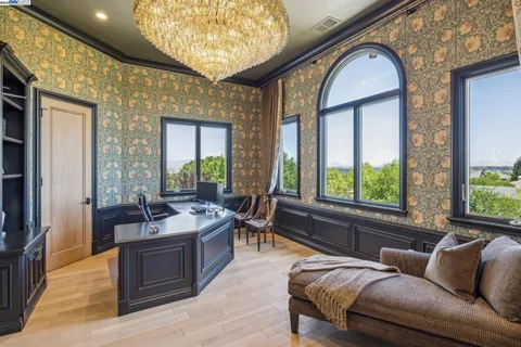 a view of cabinets a window and a wooden floor