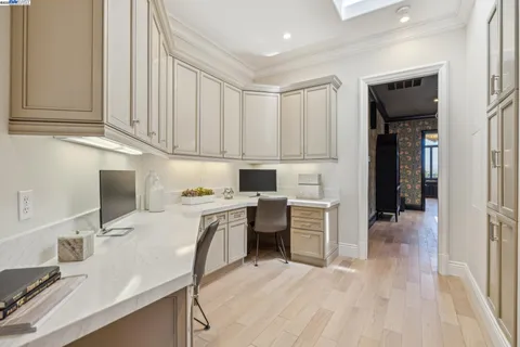 a bedroom with a bed table and a mirror