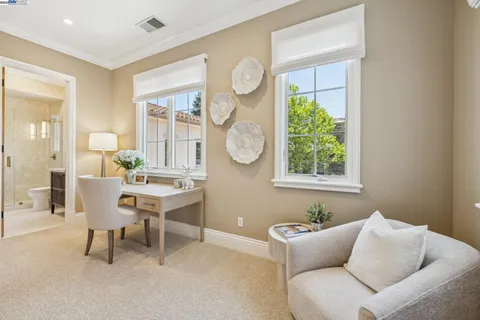 a view of dining room and wooden cabinets