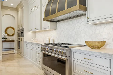 a kitchen with stainless steel appliances kitchen island wooden cabinets and fireplace