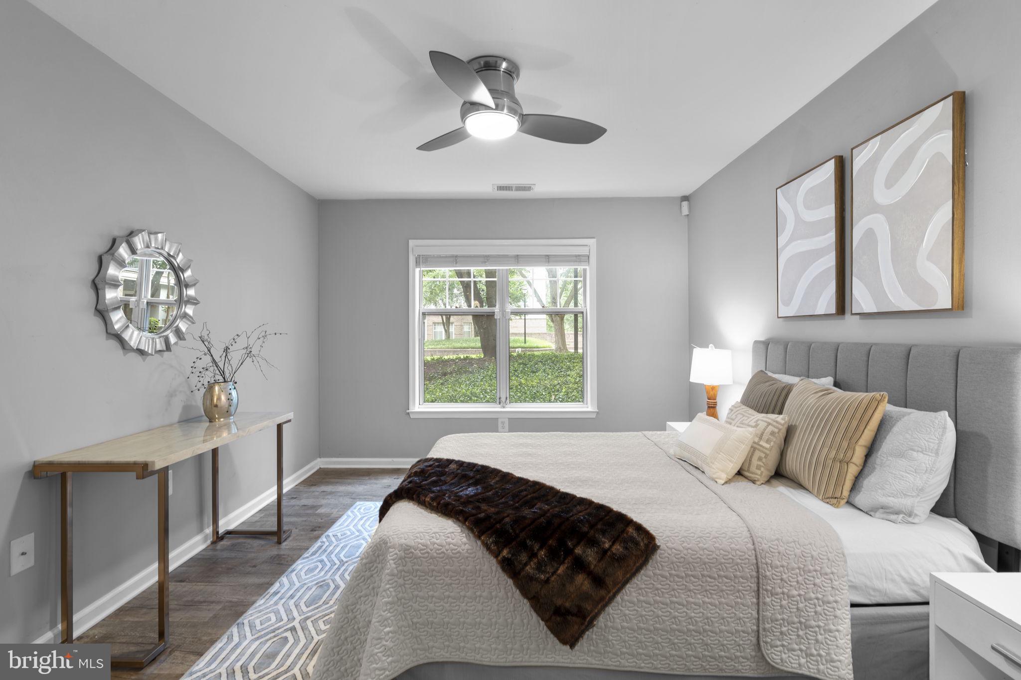 5575 Seminary Road, Unit 102 Falls Church, VA 22041 - Photo 23 of 31 a bedroom with a large bed and a chandelier
