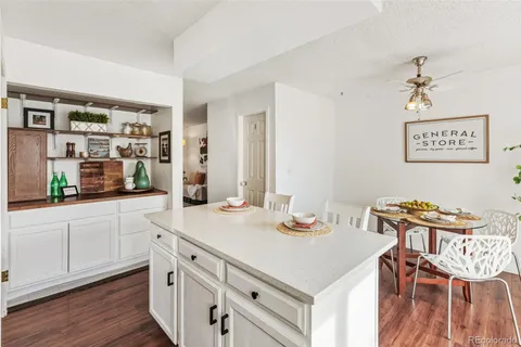 a kitchen with a sink cabinets and wooden floor