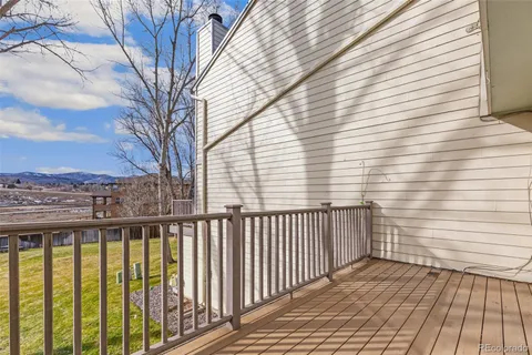 a view of a balcony with wooden fence