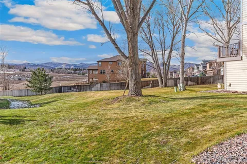 a swimming pool with trees in front of it