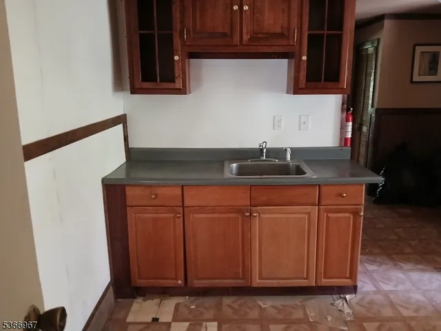 a kitchen with granite countertop cabinets and sink