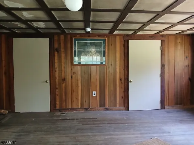a view of a room with wooden walls