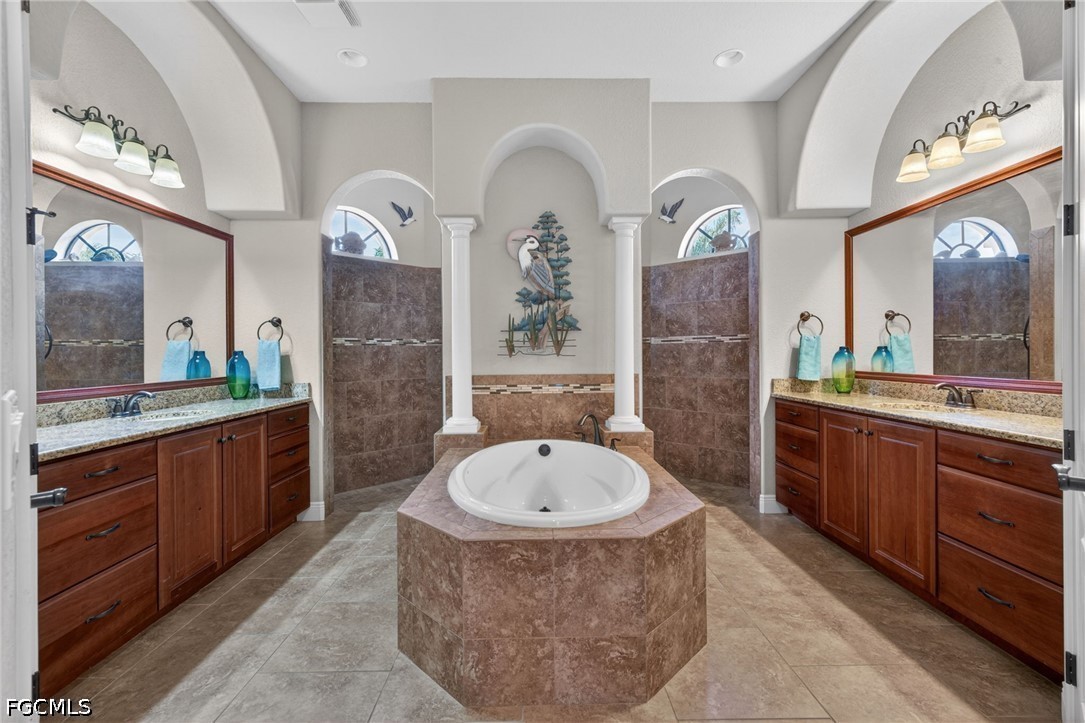 6109 Calusa Rdg Trail Bokeelia, FL 33922 - Photo 28 of 48 a spacious bathroom with a tub sink and mirror