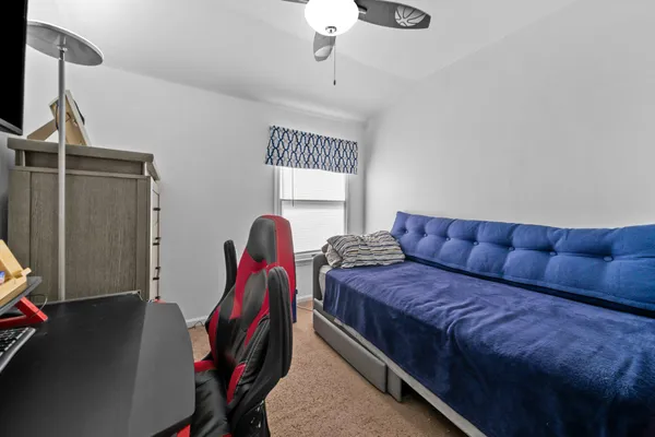a living room with furniture a air conditioner and a window