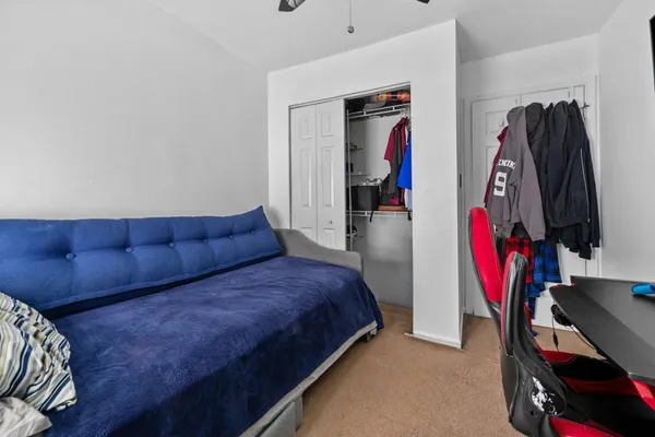 a living room with furniture and a walk in closet