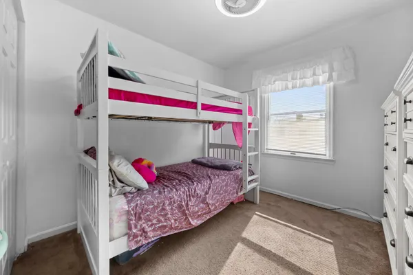 a bed room with a bed and a window