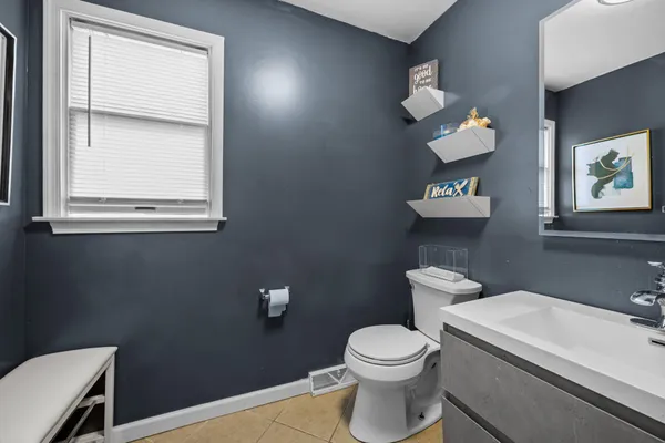 a bathroom with a toilet a sink and mirror