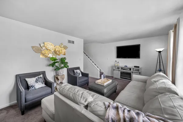a living room with furniture a couch and a flat screen tv