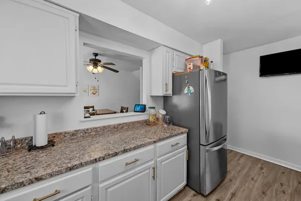 a kitchen with stainless steel appliances granite countertop a refrigerator and a sink