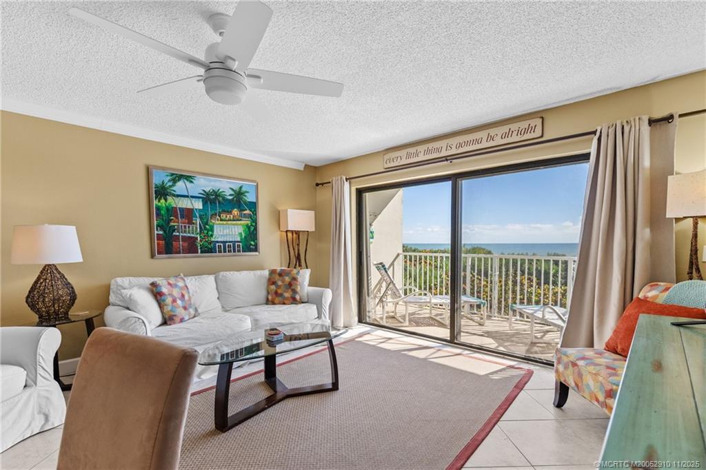379 Northeast Tradewind Lane, Unit 1104 Stuart, FL 34996 - Photo 12 of 30 a living room with furniture and a large window
