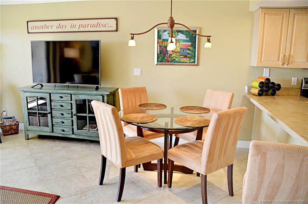 379 Northeast Tradewind Lane, Unit 1104 Stuart, FL 34996 - Photo 15 of 30 a view of a dining room with furniture and wooden floor
