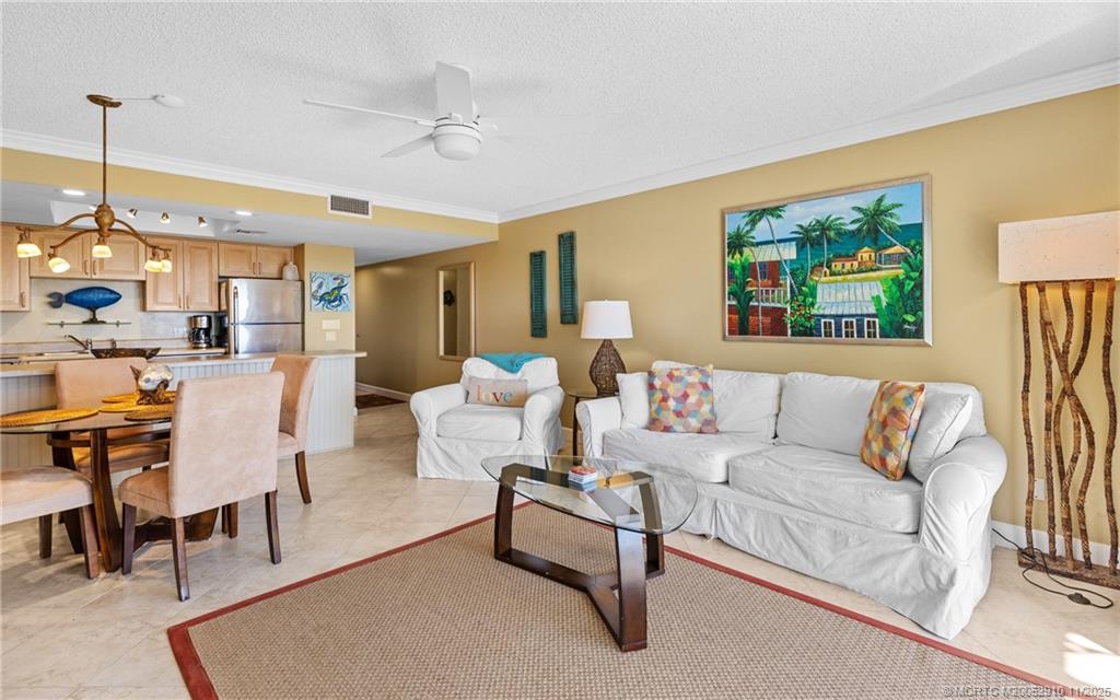 379 Northeast Tradewind Lane, Unit 1104 Stuart, FL 34996 - Photo 16 of 30 a living room with furniture and a large window