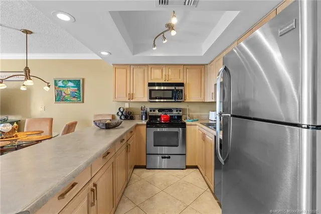 a kitchen with a refrigerator a sink and a stove