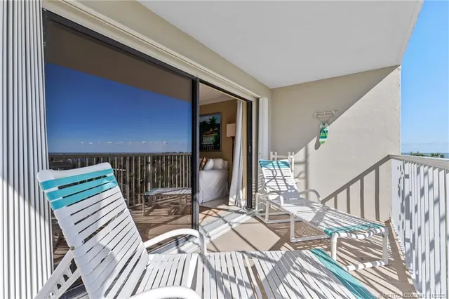 a view of a patio with table and chairs