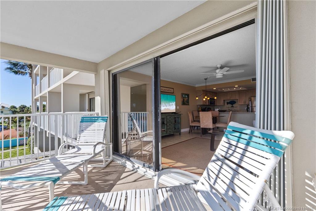 379 Northeast Tradewind Lane, Unit 1104 Stuart, FL 34996 - Photo 27 of 30 a view of a patio with table and chairs