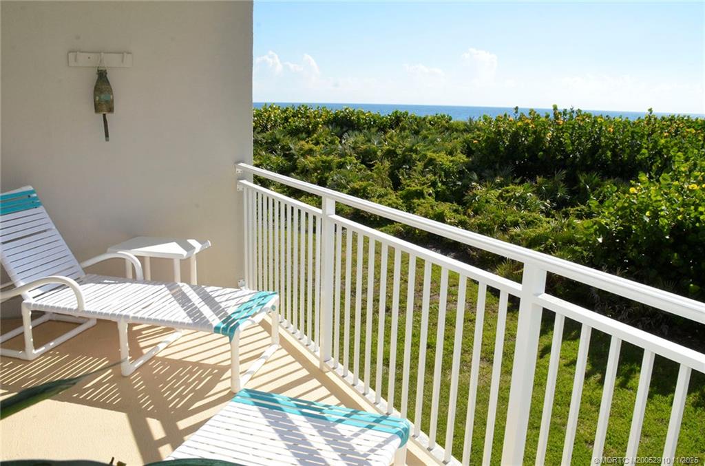 379 Northeast Tradewind Lane, Unit 1104 Stuart, FL 34996 - Photo 5 of 30 a balcony with table and chairs