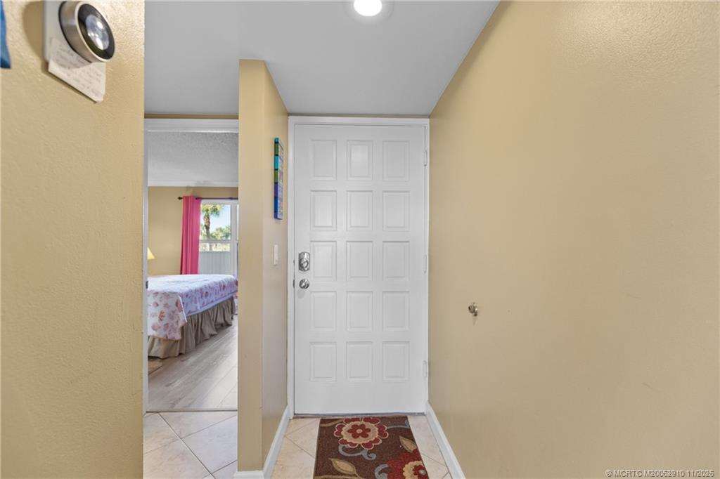 379 Northeast Tradewind Lane, Unit 1104 Stuart, FL 34996 - Photo 7 of 30 a bathroom with a sink and a mirror
