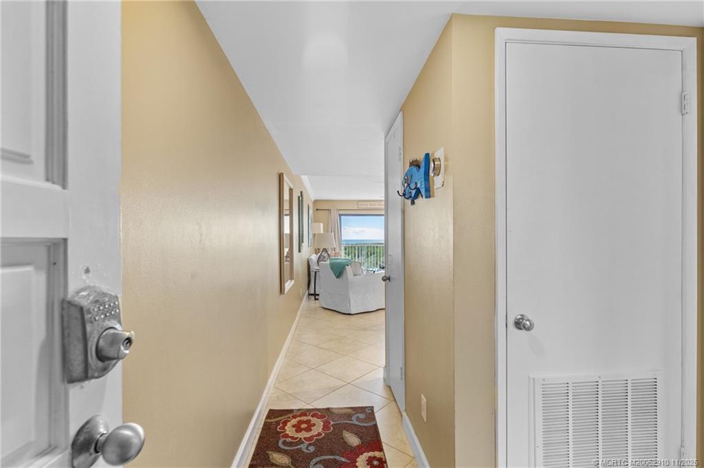 379 Northeast Tradewind Lane, Unit 1104 Stuart, FL 34996 - Photo 8 of 30 a view of a hallway with wooden floor and dining room