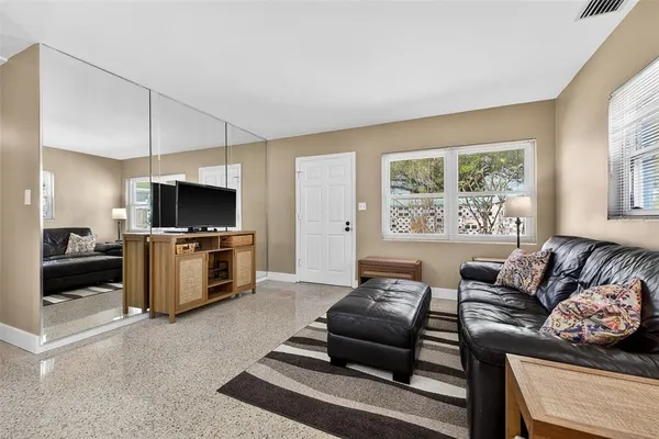 a living room with furniture and a flat screen tv