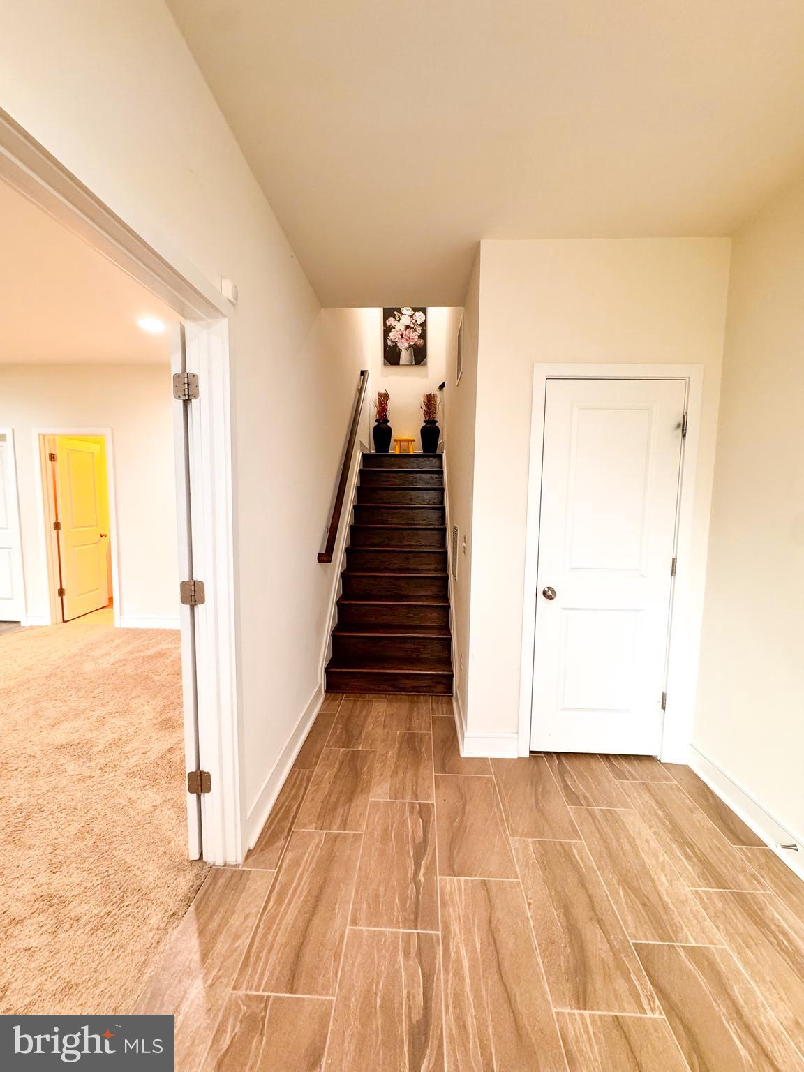 25419 Reed Orchard Terrace Chantilly, VA 20152 - Photo 13 of 47 a view of a hallway with wooden floor and staircase