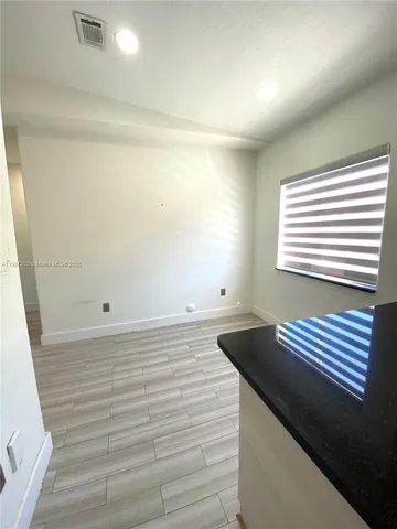a view of wooden floor and windows in a room