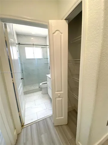 a bathroom with a glass shower door and a bathtub