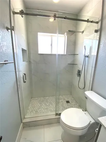 a bathroom with a shower and a toilet