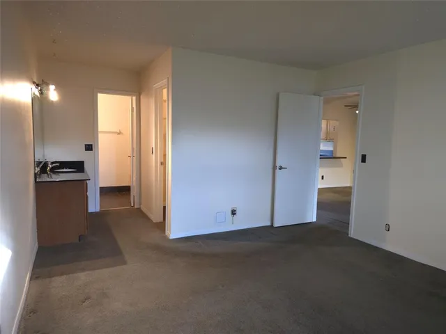 a kitchen with granite countertop a sink and a stove