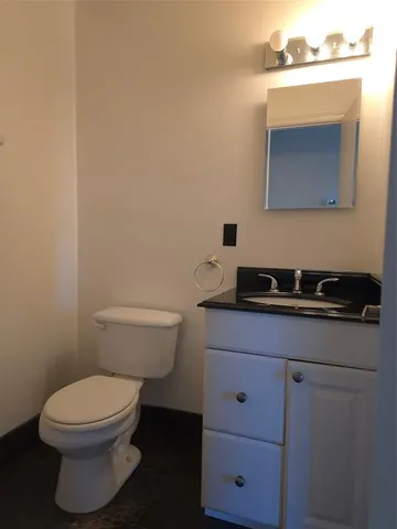 a view of an empty room with a fireplace and a window