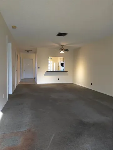 an empty room with a empty space and windows