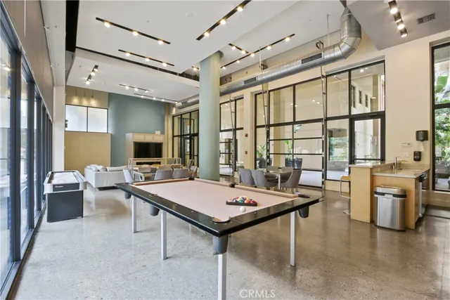 a living room with furniture a large window and a table