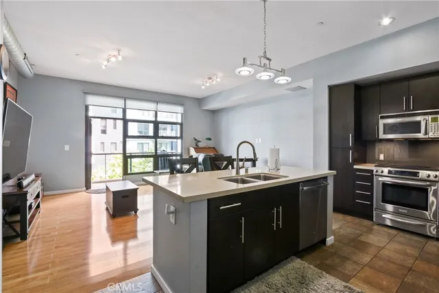 a kitchen with stainless steel appliances a sink stove and oven