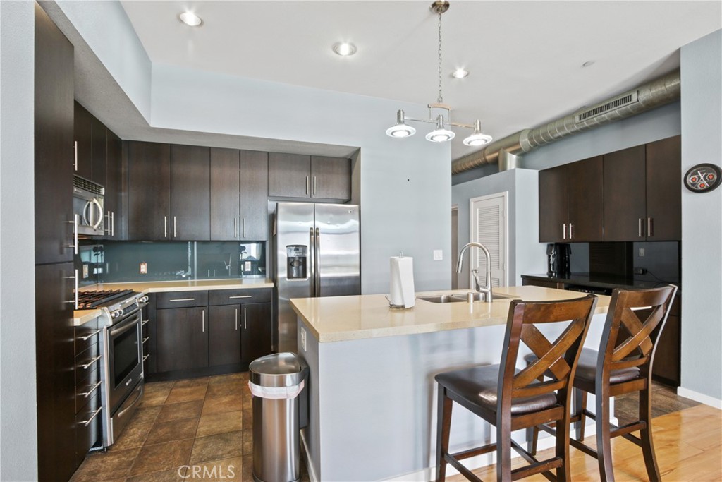 133 The Promenade North, Unit 330 Long Beach, CA 90802 - Photo 4 of 17 a kitchen with granite countertop a sink stove and refrigerator