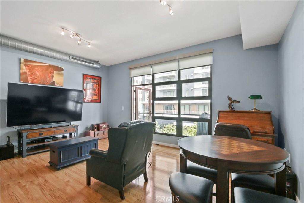 133 The Promenade North, Unit 330 Long Beach, CA 90802 - Photo 5 of 17 a living room with furniture and a flat screen tv