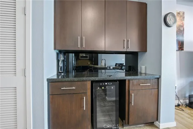 a kitchen with granite countertop a cabinets and a stove top oven