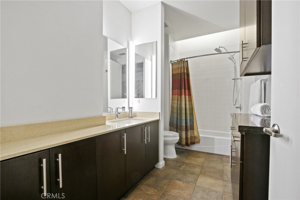 133 The Promenade North, Unit 330 Long Beach, CA 90802 - Photo 7 of 17 a bathroom with a double vanity sink a toilet and a tub