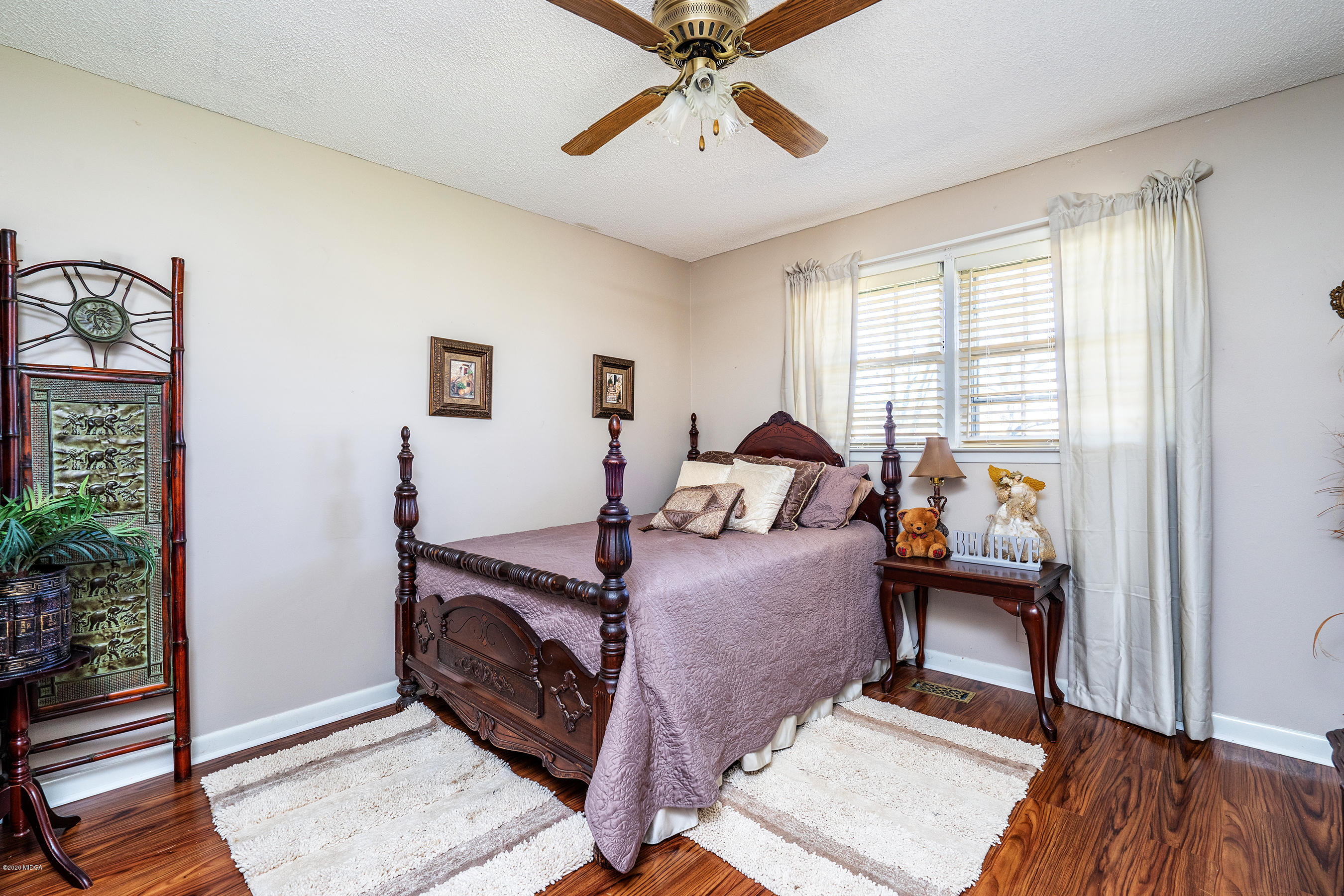 5720 School Road Macon, GA 31216 - Photo 23 of 31 a bedroom with a bed and wooden floor