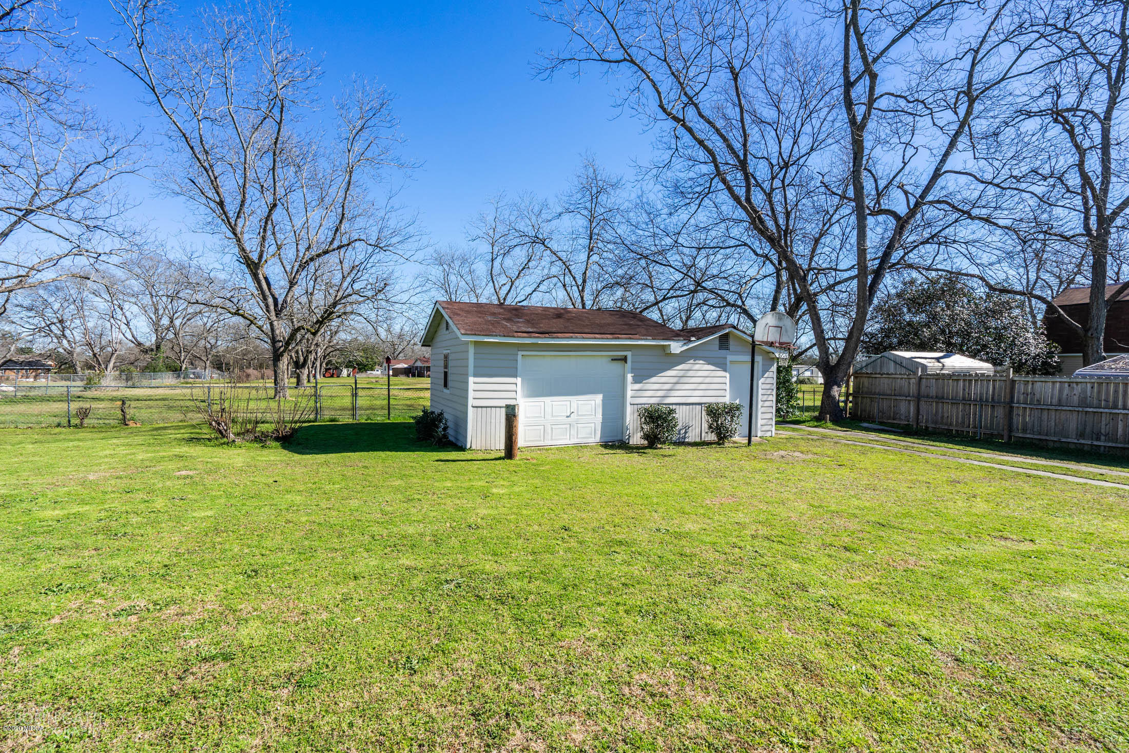 5720 School Road Macon, GA 31216 - Photo 27 of 31 a front view of a house with a garden and trees