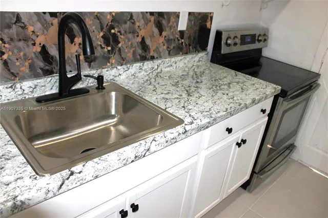a kitchen with white cabinets and white appliances