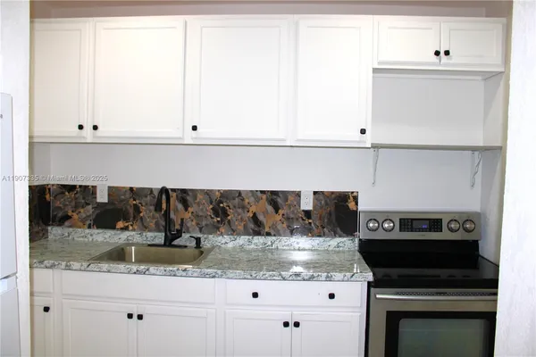 a kitchen with a sink and cabinets