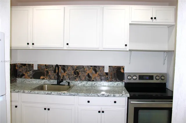 a kitchen with a sink and cabinets